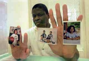 Reed, pictured on death-row with images of his children.